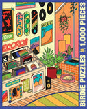 A colorful jigsaw puzzle box cover or puzzle artwork showing a stylized illustrated room with vinyl records, skateboards, plants, posters, and a cat. Large vertical text on the right reads 'BIRDIE PUZZLES 1,000 PIECES'.