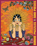 A colorful illustrated jigsaw puzzle box cover reading 'BIRDIE PUZZLES 500 PIECES.' The artwork shows a seated woman with a radiant yellow halo, blue patterned clothing, flowers, butterflies, jewelry, and decorative objects on a warm orange and pink background.
